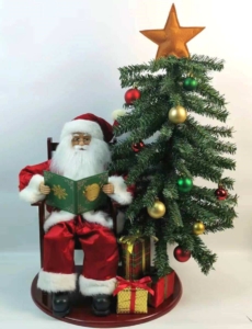 Santa Sitting Next to Christmas Tree